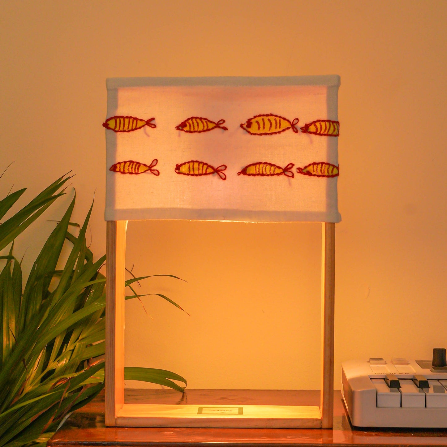 Pine Glow Madhubani Charm Lamp – Hand-Painted and hand embroidered Wooden Table Lamp with Fish Motif